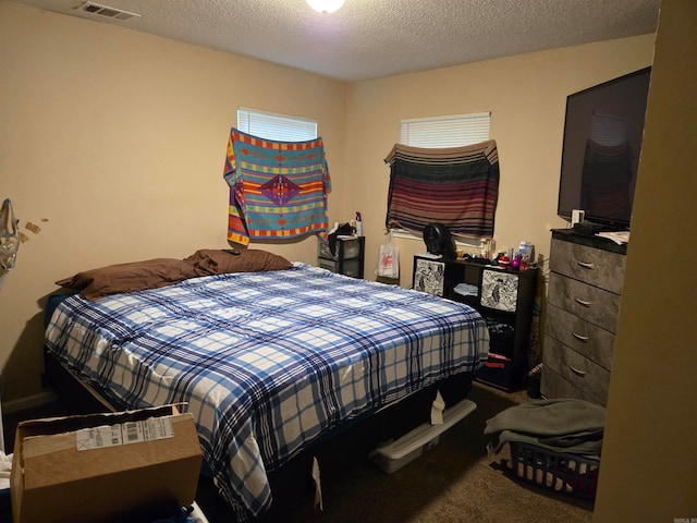 bedroom with a textured ceiling and carpet flooring