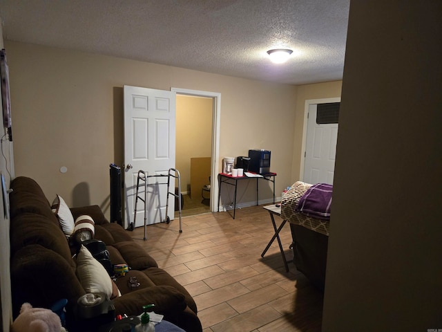 living room with wood-type flooring and a textured ceiling