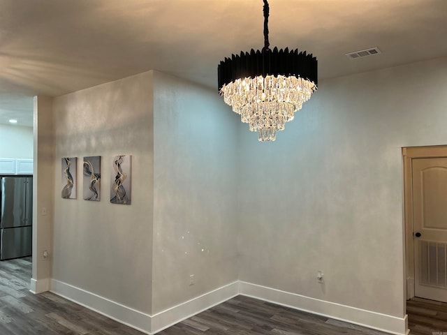 dining area featuring an inviting chandelier and dark wood-type flooring