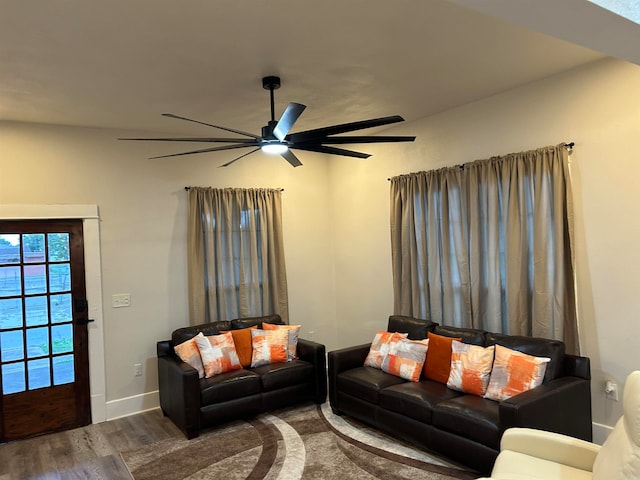 living room featuring wood-type flooring and ceiling fan