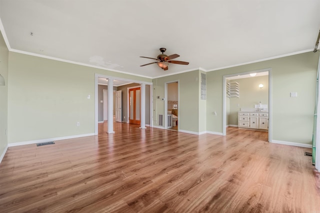 unfurnished living room featuring light hardwood / wood-style flooring, ceiling fan, ornamental molding, and ornate columns