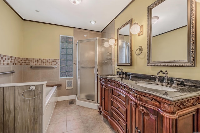 bathroom with ornamental molding, tile patterned flooring, independent shower and bath, and vanity