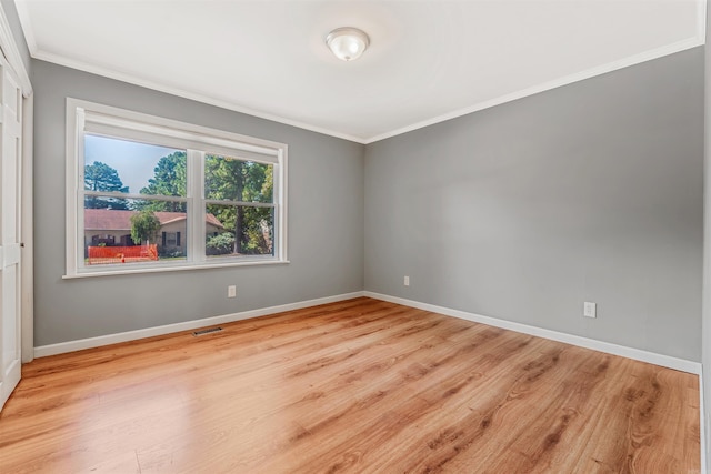 unfurnished room with light hardwood / wood-style flooring and ornamental molding