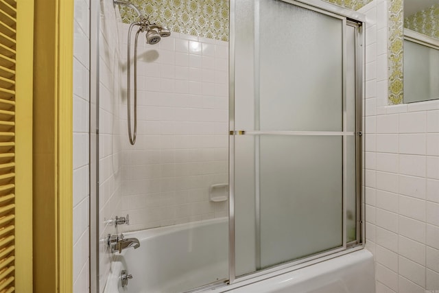 bathroom featuring bath / shower combo with glass door and radiator