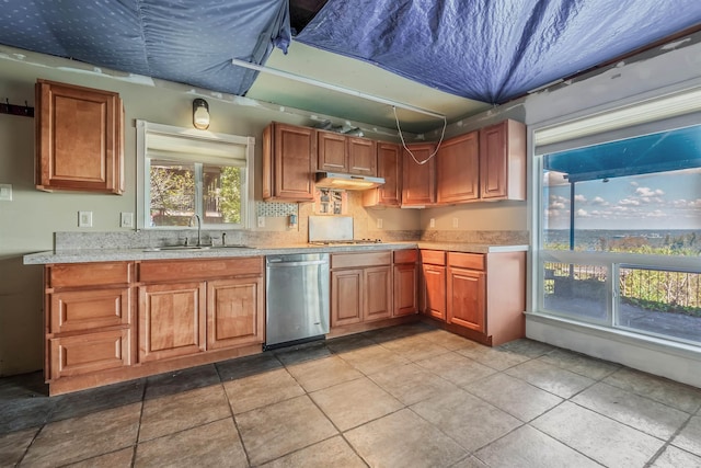 kitchen with dishwasher, light tile patterned flooring, and sink