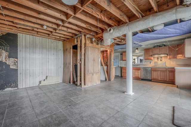 basement featuring wooden walls