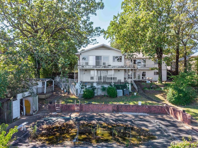 rear view of property with a balcony