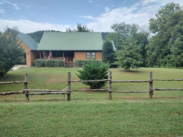 view of front of house with a rural view and a front yard