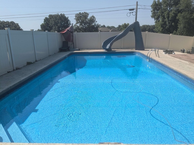 view of pool featuring a fenced in pool, a water slide, and a fenced backyard