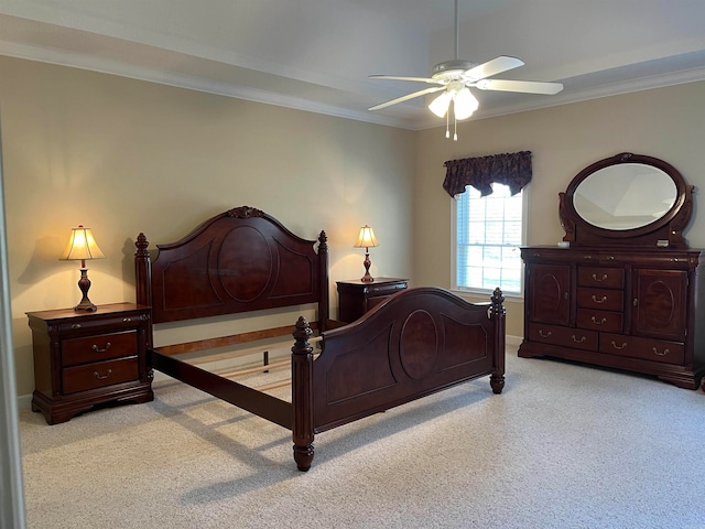 carpeted bedroom with ceiling fan and ornamental molding