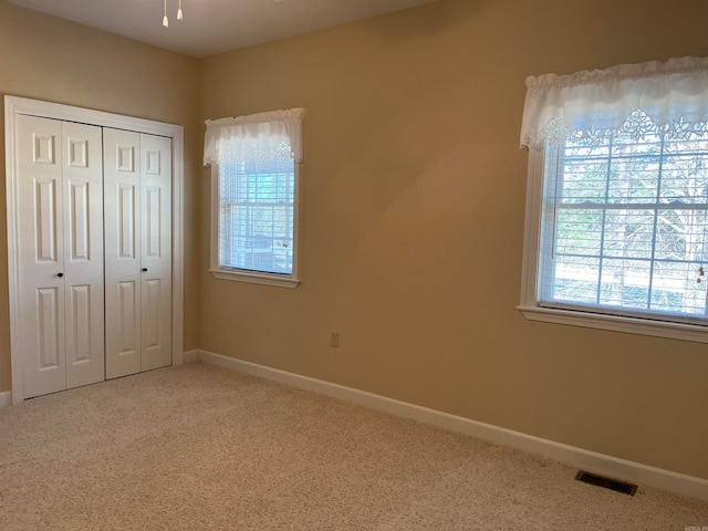 unfurnished bedroom with a closet and carpet flooring