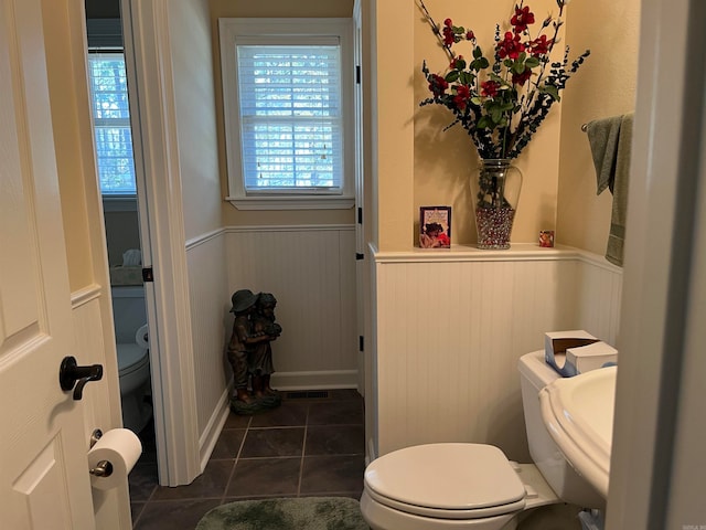 bathroom with tile patterned flooring and toilet