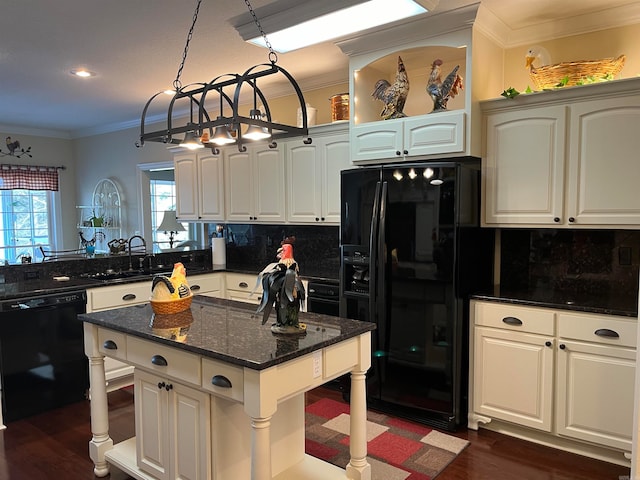 kitchen with dark stone counters, black appliances, dark hardwood / wood-style flooring, and hanging light fixtures