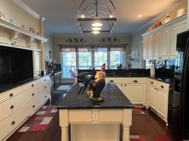 kitchen featuring an inviting chandelier, ornamental molding, dark hardwood / wood-style floors, and decorative light fixtures