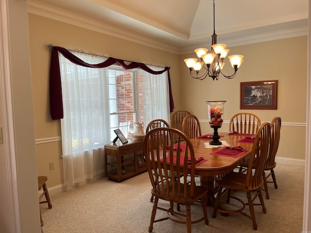 dining room with light colored carpet, a chandelier, and ornamental molding