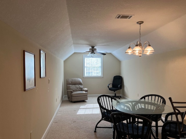 carpeted dining area with a textured ceiling, ceiling fan with notable chandelier, and lofted ceiling