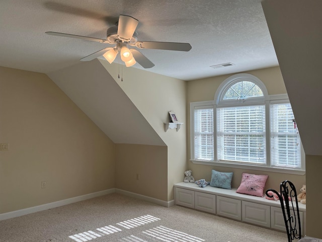 bonus room featuring light carpet, vaulted ceiling, a textured ceiling, and ceiling fan