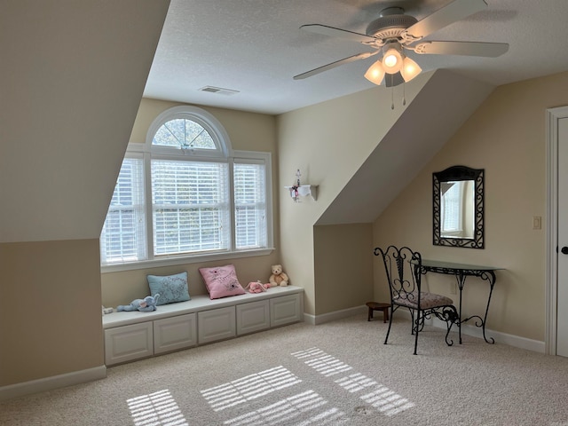 additional living space featuring ceiling fan, light colored carpet, and a healthy amount of sunlight