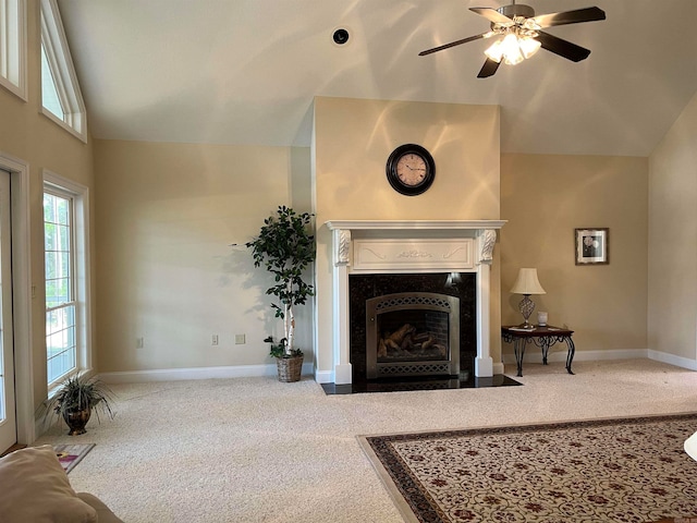 living room with carpet floors, ceiling fan, a high end fireplace, and high vaulted ceiling