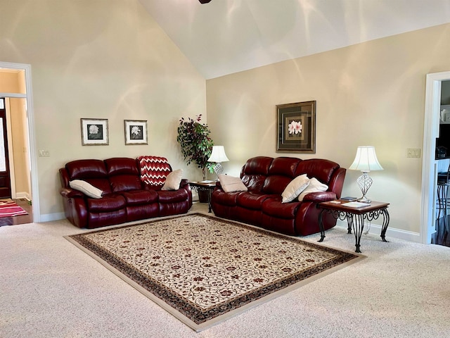 carpeted living room featuring high vaulted ceiling