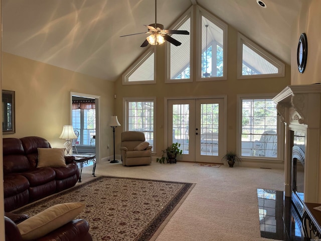 living room with high vaulted ceiling, ceiling fan, carpet flooring, and french doors