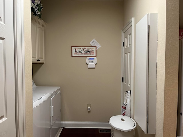 laundry area featuring cabinets and washer and dryer