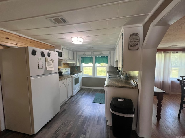 kitchen with sink, dark wood-type flooring, white appliances, and white cabinetry