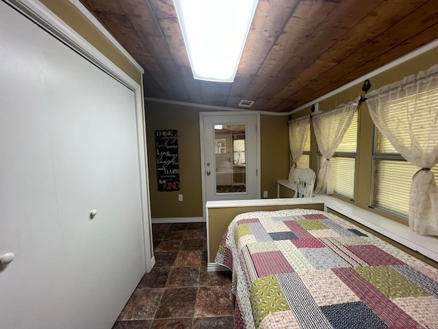 unfurnished bedroom with ornamental molding, wood ceiling, vaulted ceiling, and a closet