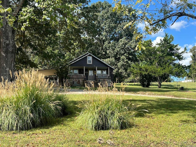 view of front of house with a front yard and a porch