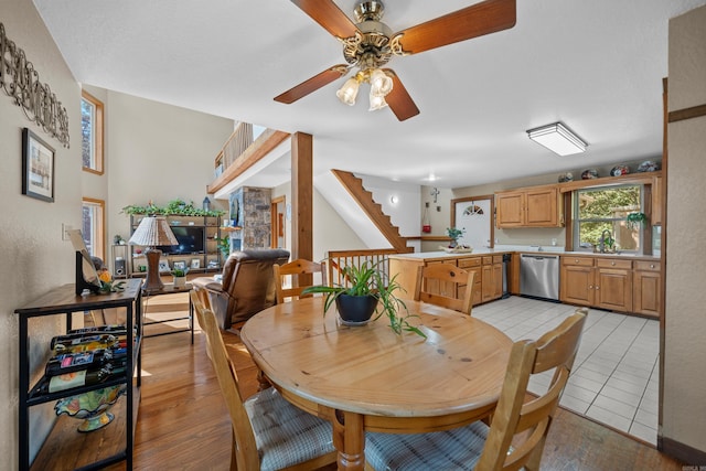 tiled dining space featuring ceiling fan and sink