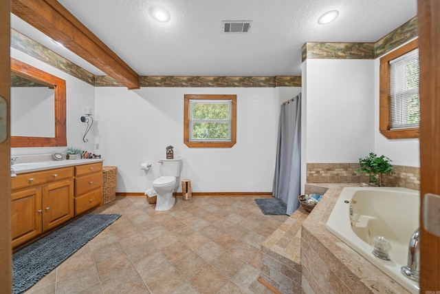 full bathroom with a textured ceiling, plenty of natural light, vanity, and toilet