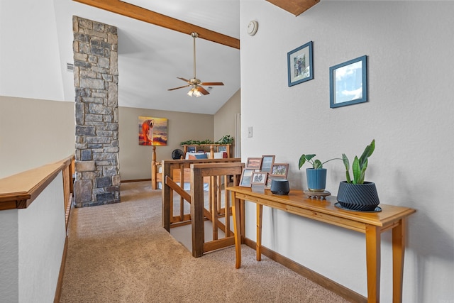 interior space featuring vaulted ceiling with beams, light carpet, and ornate columns