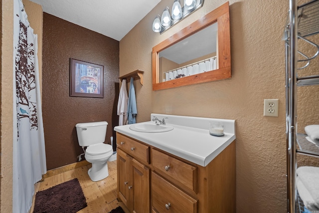 bathroom featuring wood-type flooring, vanity, toilet, and a shower with shower curtain