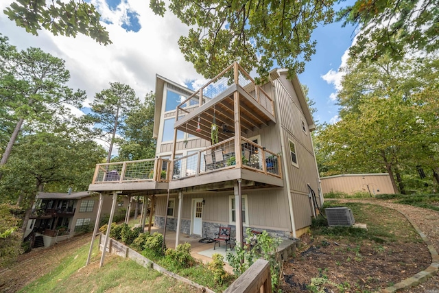 back of house featuring a wooden deck, central AC, and a patio area