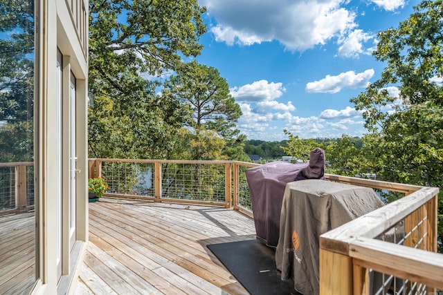 wooden deck with a grill