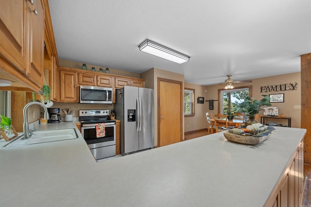 kitchen featuring ceiling fan, appliances with stainless steel finishes, and sink