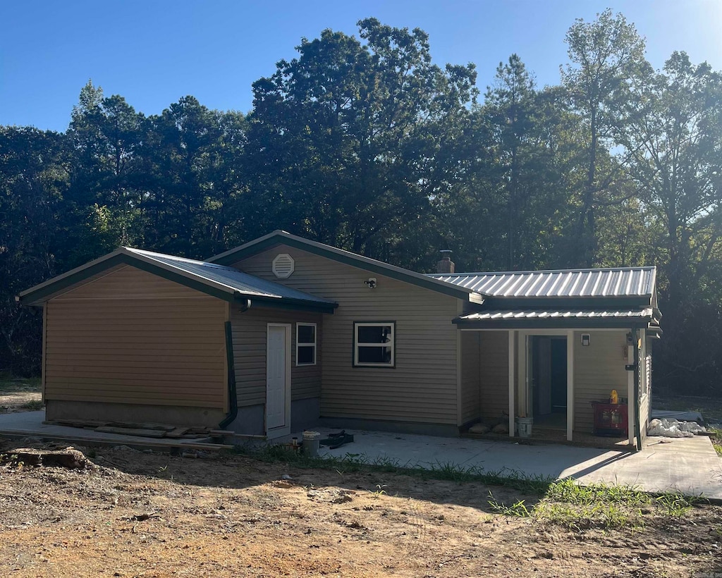 back of property with a patio