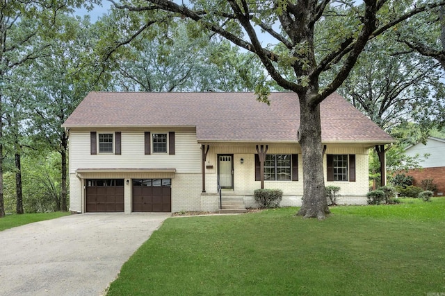 split level home with a front yard and a garage