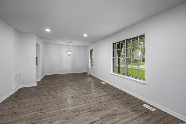 empty room featuring dark wood-type flooring