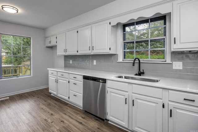 kitchen with dark hardwood / wood-style flooring, white cabinets, sink, and stainless steel dishwasher