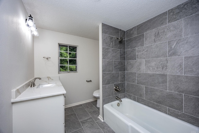 full bathroom featuring a textured ceiling, tiled shower / bath combo, vanity, and toilet