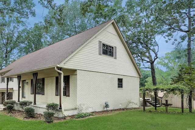 view of home's exterior featuring a yard and covered porch