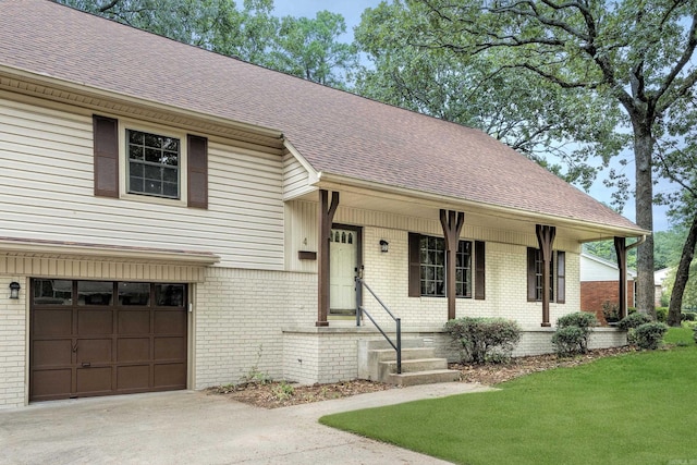 view of front of home with a front lawn and a garage