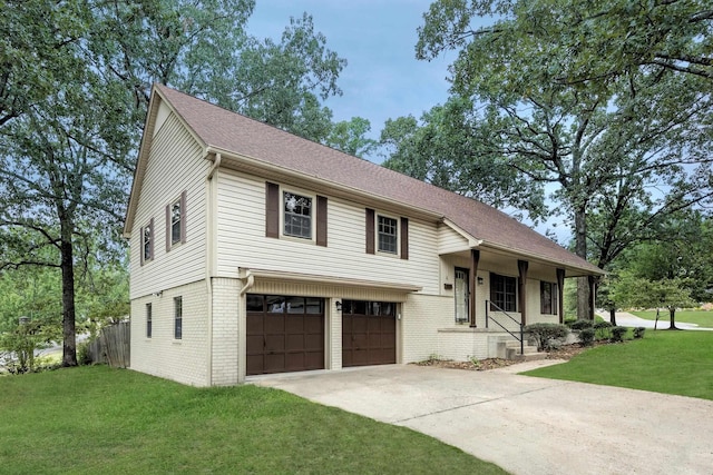 tri-level home featuring a garage and a front yard