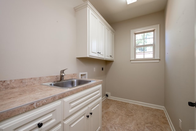 clothes washing area with hookup for a washing machine, cabinets, sink, and hookup for an electric dryer