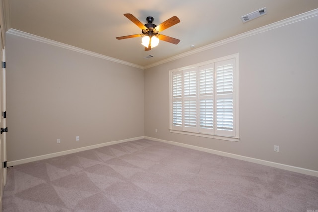 carpeted empty room featuring ceiling fan and crown molding