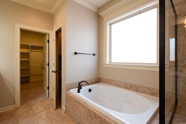 bathroom featuring ornamental molding and tiled bath