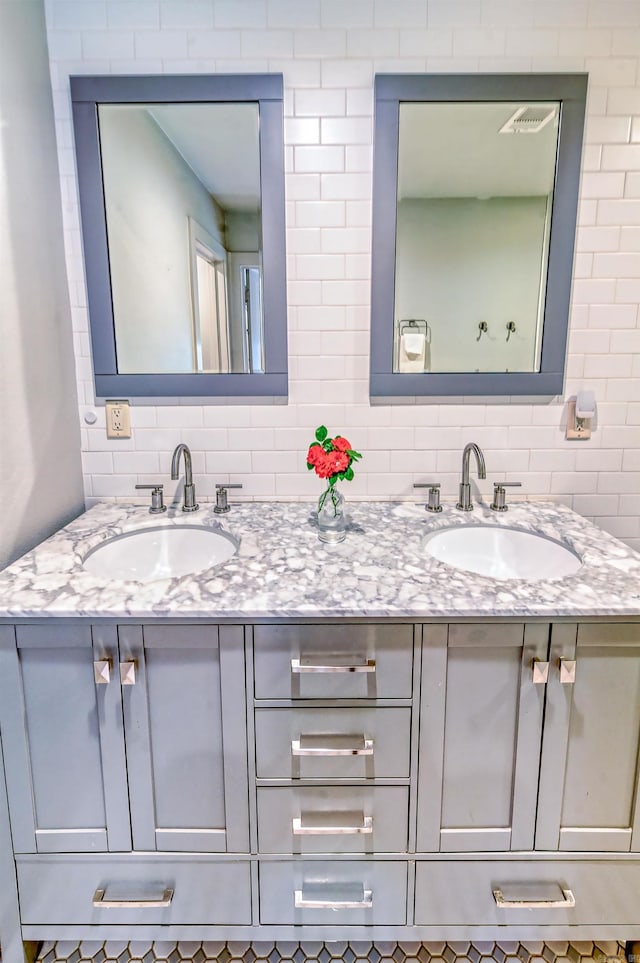 bathroom with vanity and tasteful backsplash