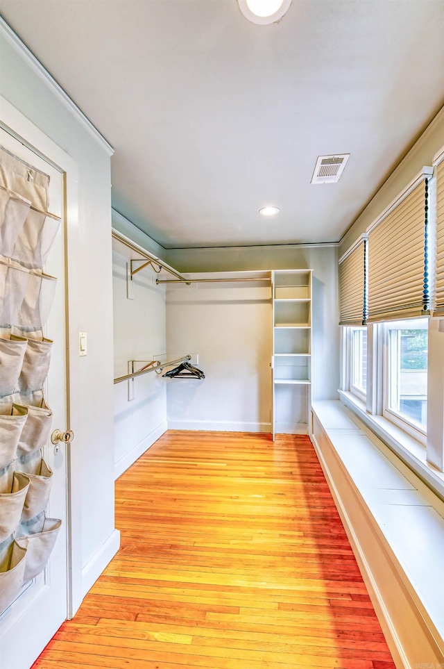 spacious closet featuring light hardwood / wood-style floors