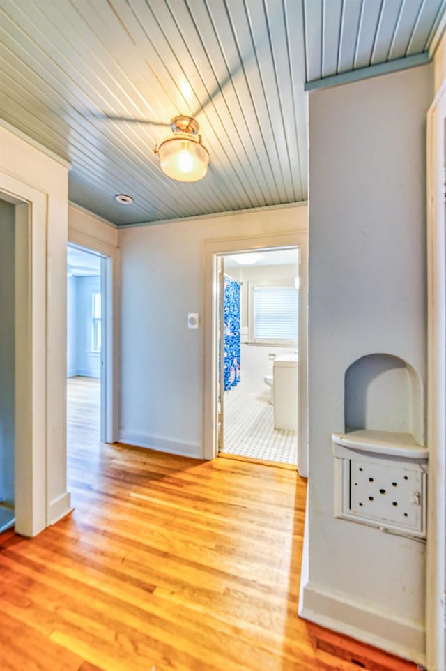 corridor with wood ceiling and light wood-type flooring